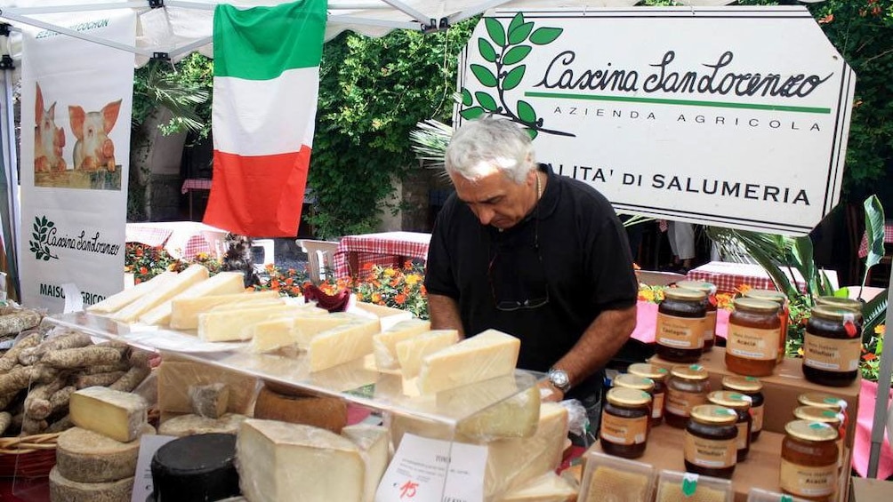 Show item 2 of 5. Shopping for Italian cheese at the market in Cannes