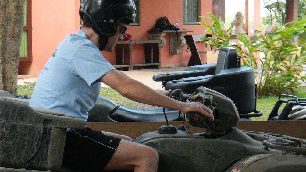 Side shot of man steering ATV