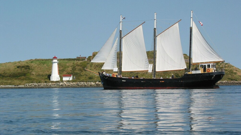 Tall Ship Silva sailing near lighthouse