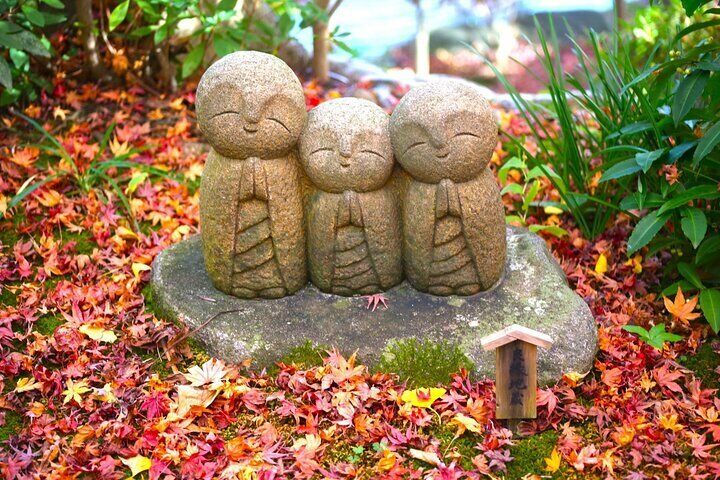 Hasedera's adorable Jizo statues surrounded by a tapestry of autumn leaves.