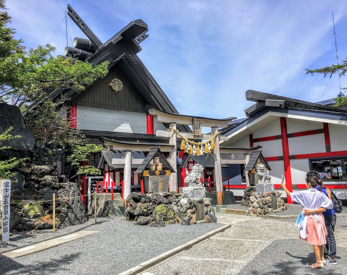 Man and woman at shinto shrine in Japan