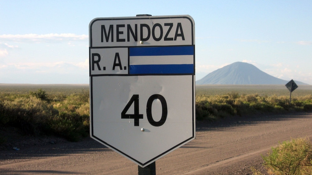 Highway in Mendoza with a mountain towering above the landscape