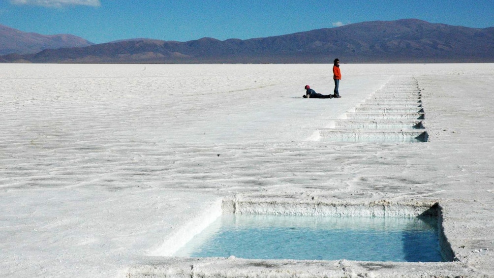 Row of square pools of clear water along the salt fields in Argentina