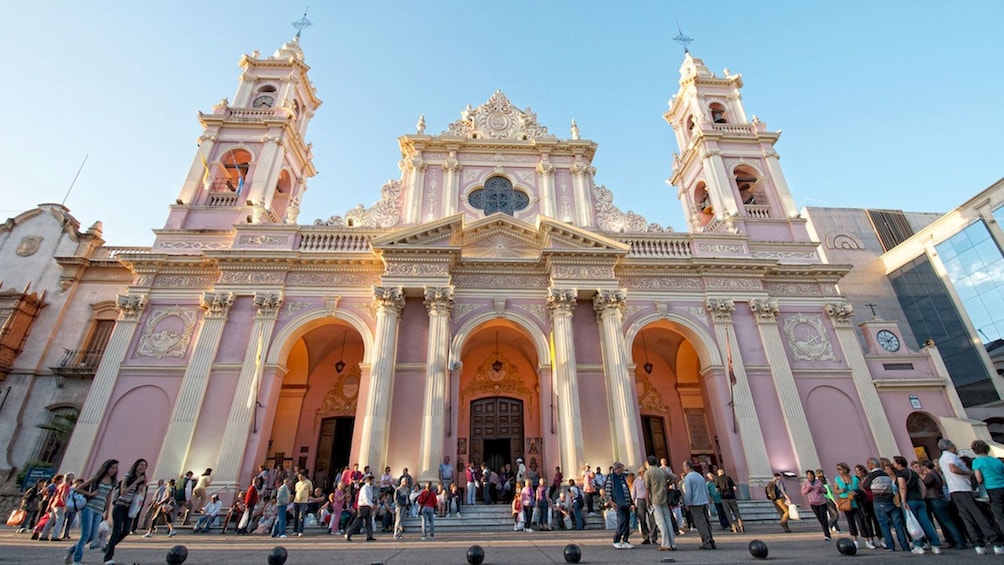 Crowds gathered at a pink historical building in Salta