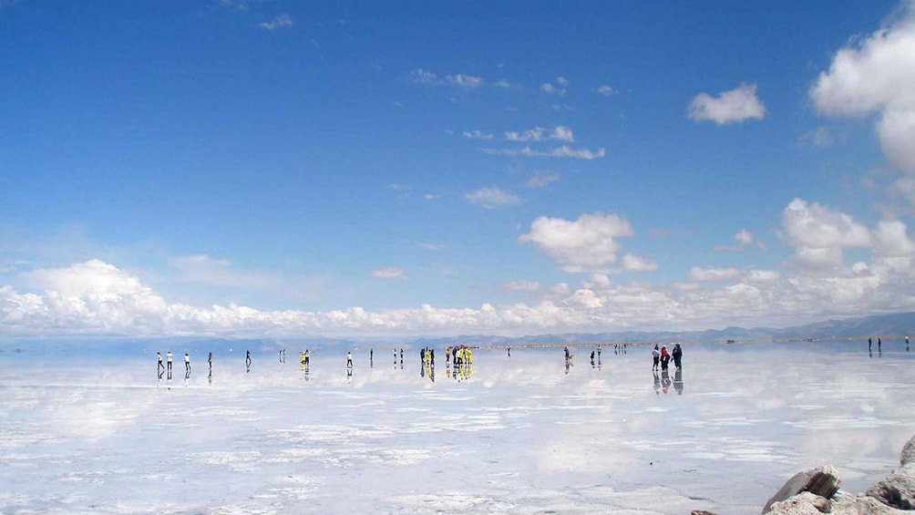 Tour groups walking along the salt desert in Salinas Grandes in Argentina