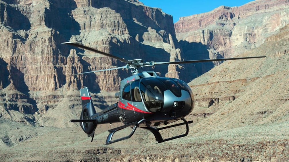 Helicopter flying over Hoover Dam.