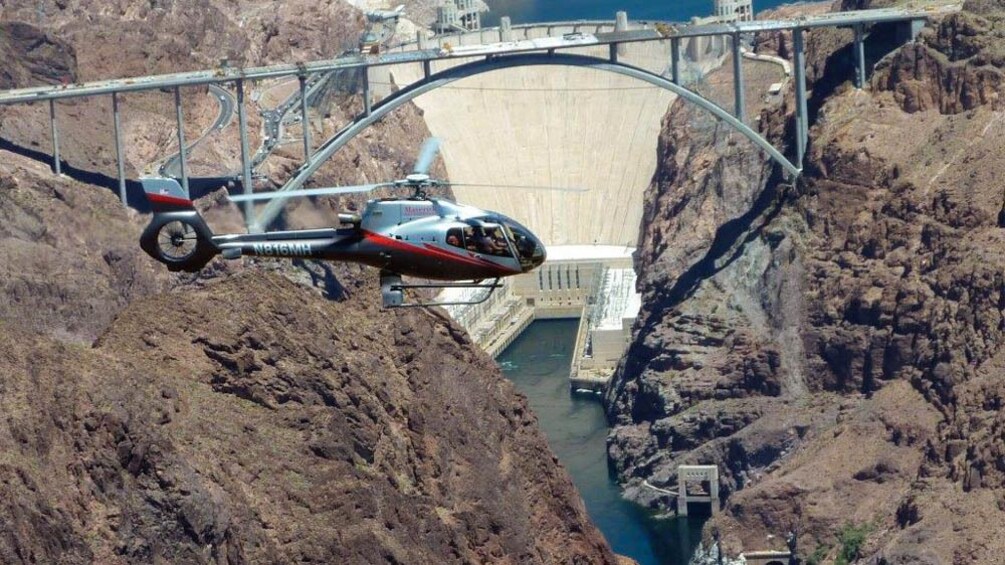 Helicopter flying over Hoover Dam.