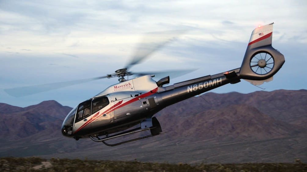 Helicopter flying over Hoover Dam.