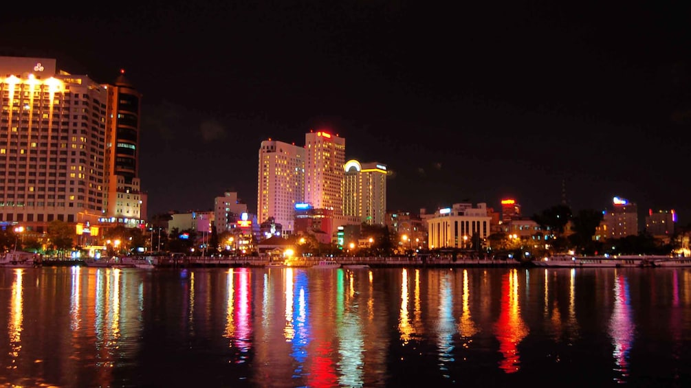 Stunning panoramic nigh view of the city of Ho Chi Minh aboard the Saigon River Dinner Cruise 