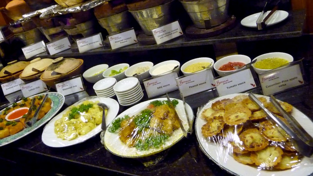 Show item 4 of 9. Buffet food station aboard the Saigon River Dinner Cruise in Ho Chi Minh City