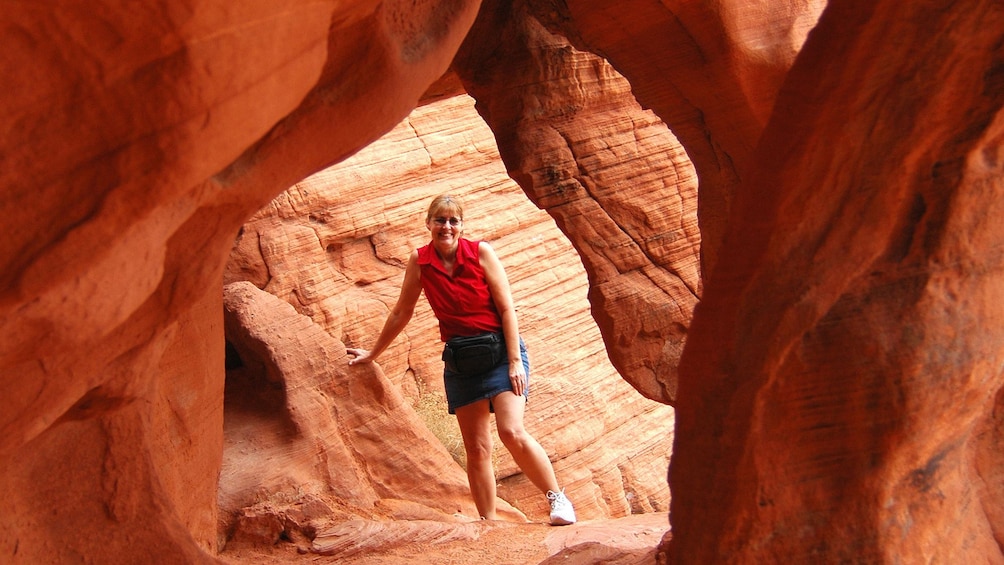 Happy woman posing for a quick photo within the rock formations in the Valley of Fire