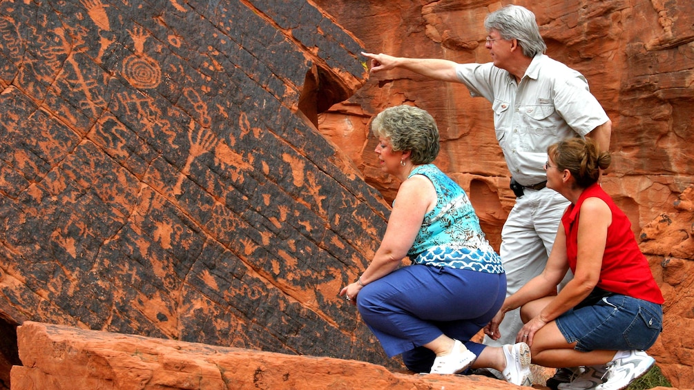 Tourists inspect ancient cave drawings