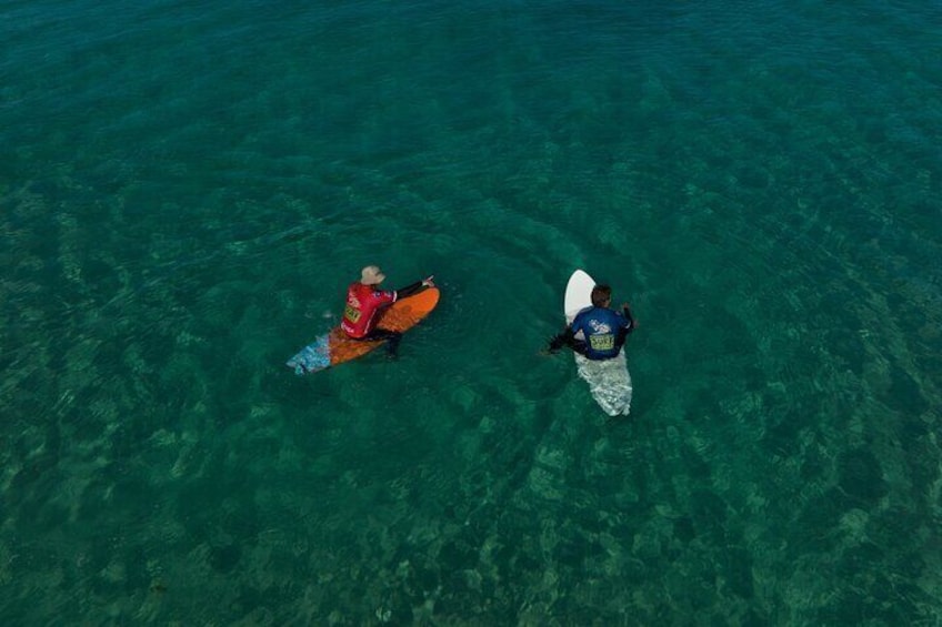 A crystal-clear connection between coach and student, seen from above. Our lessons take place in pristine waters