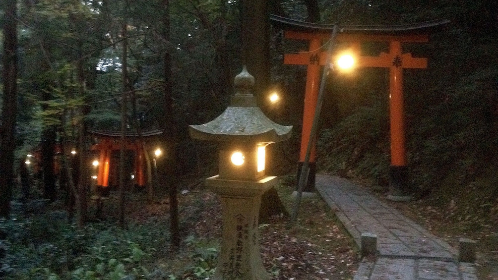 Show item 2 of 5. lantern lights illuminate the path to Fushimi Inari shrine in Kyoto