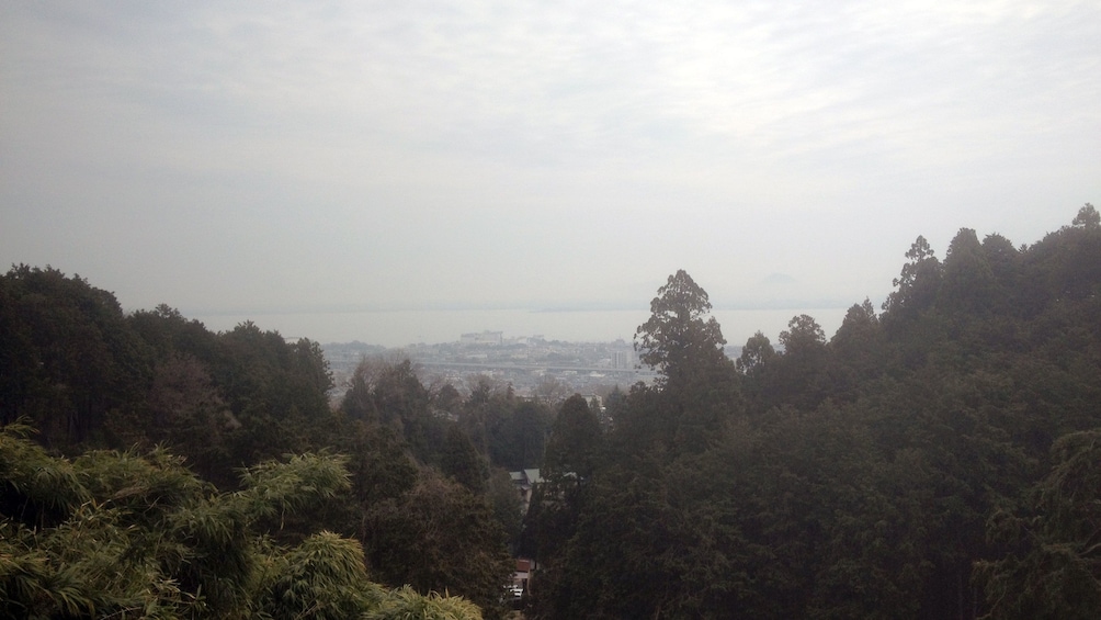 Show item 4 of 5. a view looking down at Kyoto and the coast on a misty morning
