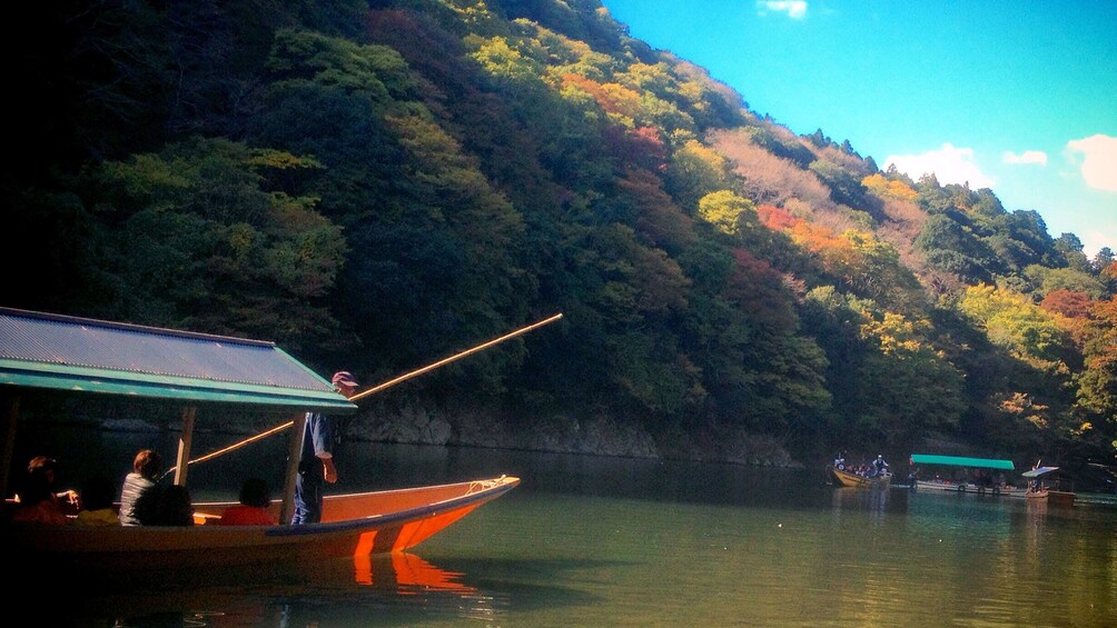 Show item 4 of 7. People traveling down river in Kyoto