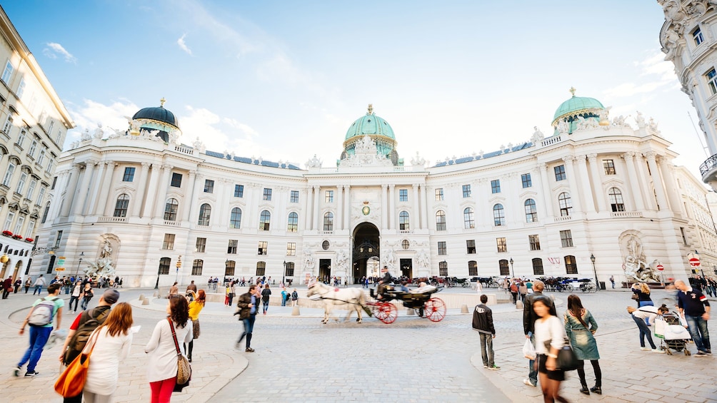 Show item 2 of 7. People walking through courtyard outside Hofburg Palace in Vienna