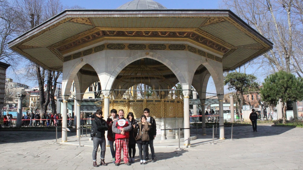 Tourist group stands for a picture in front of a building in Istanbul 