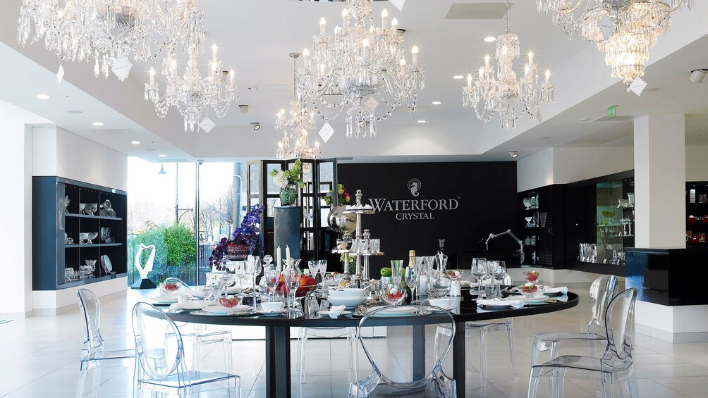 crystal chandeliers and stemware on table inside Waterford Crystyaltour in Dublin