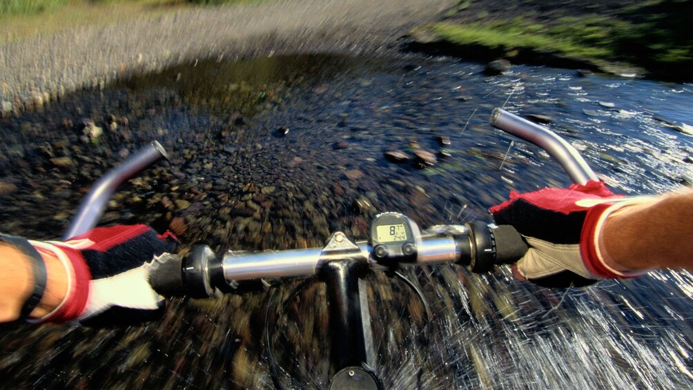 Biking through a shallow creek in Denver