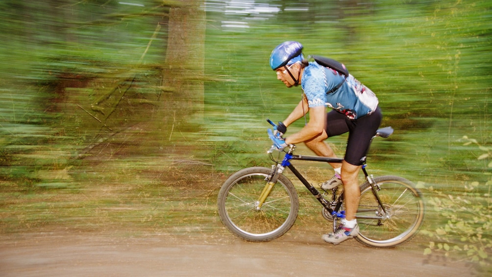 Mountain biking along a wooded trail in Denver