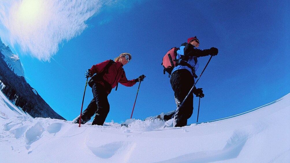 Couple snowshoeing on a clear day in Denver