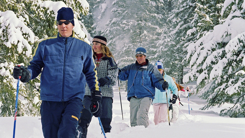 Group snowshoeing in knee deep snow in Denver