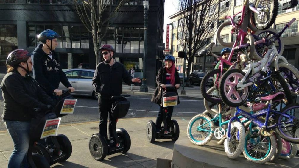 Guide tell group on segways about pile of bicycles and zoobooming in Portland