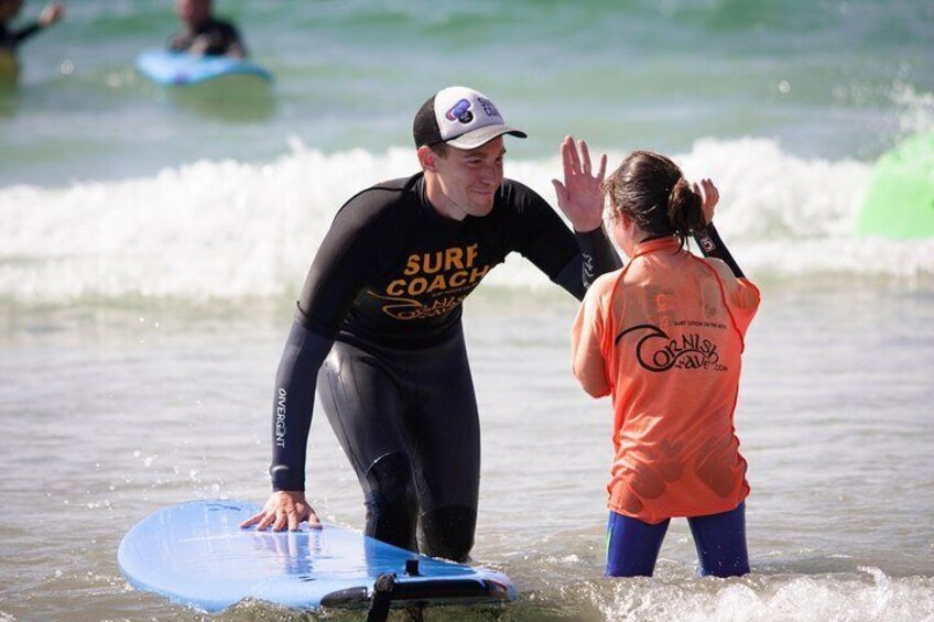 High fives with family surfing Newquay. 