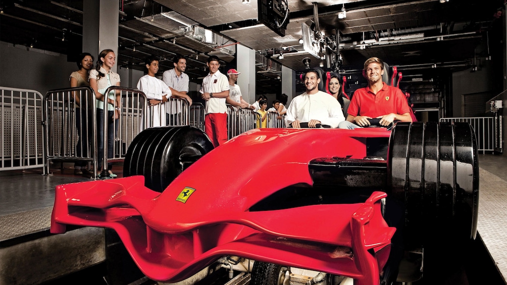 People getting onto a roller coaster ride at Ferrari World in Dubai