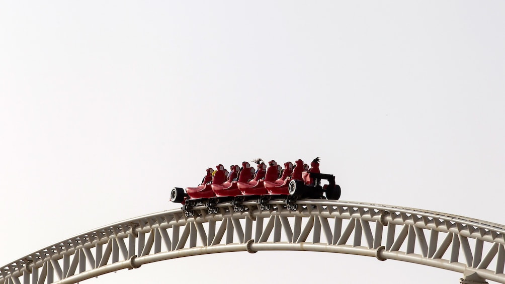 People riding a roller coaster at Ferrari World in Dubai