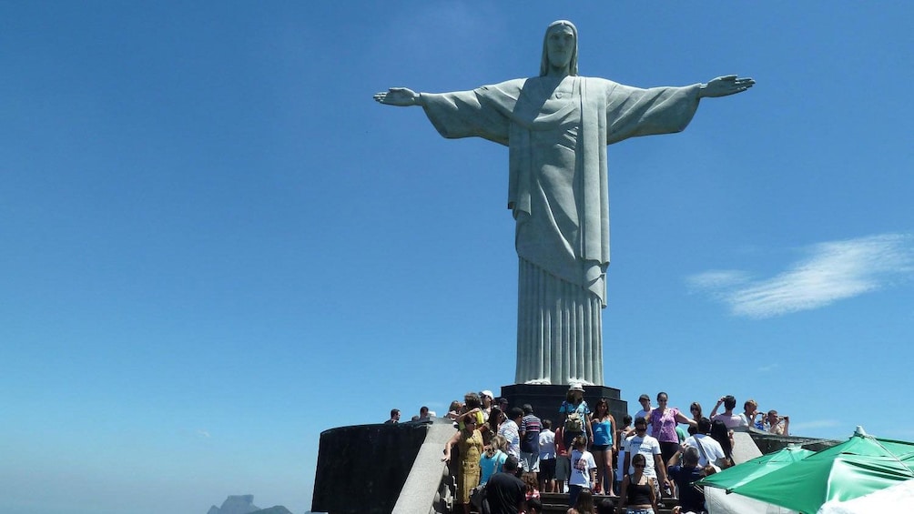 Tour group at the base of Christ the Redeemer on top of Corcovado Mountain in Rio de Janeiro