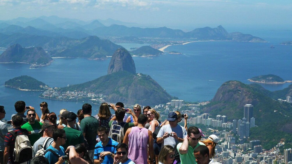 Group looking down at the city and Sugarloaf Mountain from Corcovado in Rio de Janeiro