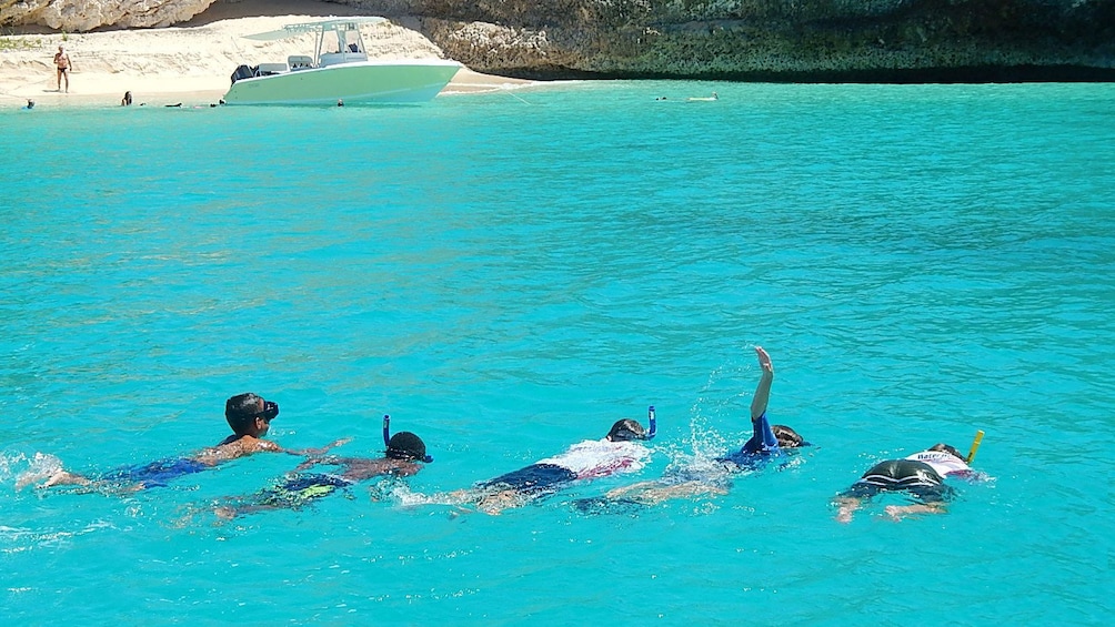 Group of children snorkeling in a secluded secret cove
