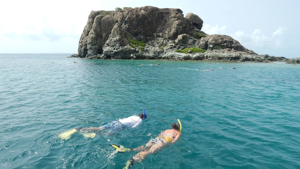 Couple snorkeling off the shores of Creole Rock in the Caribbean