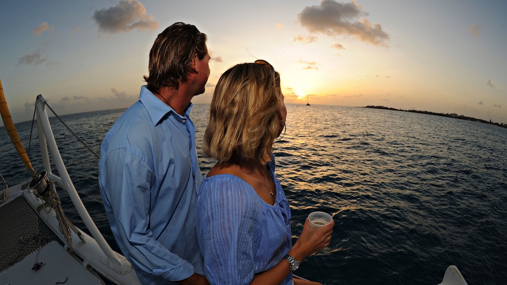 Couple enjoying the sunset onboard the Lambada catamaran