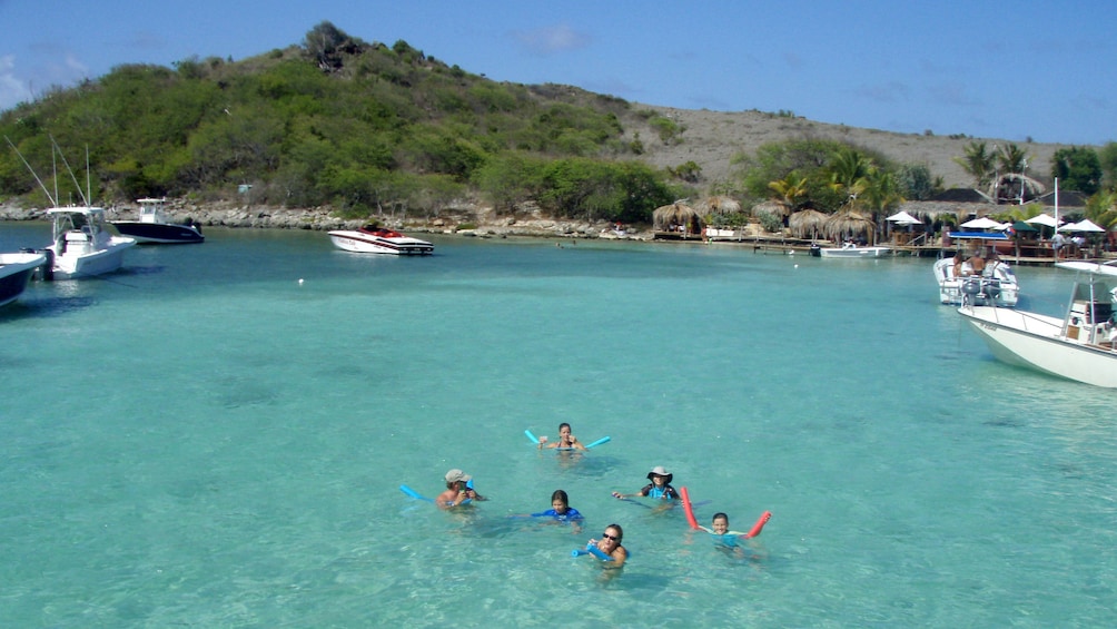 Group of tourists snorkeling off the coast of Tintamarre