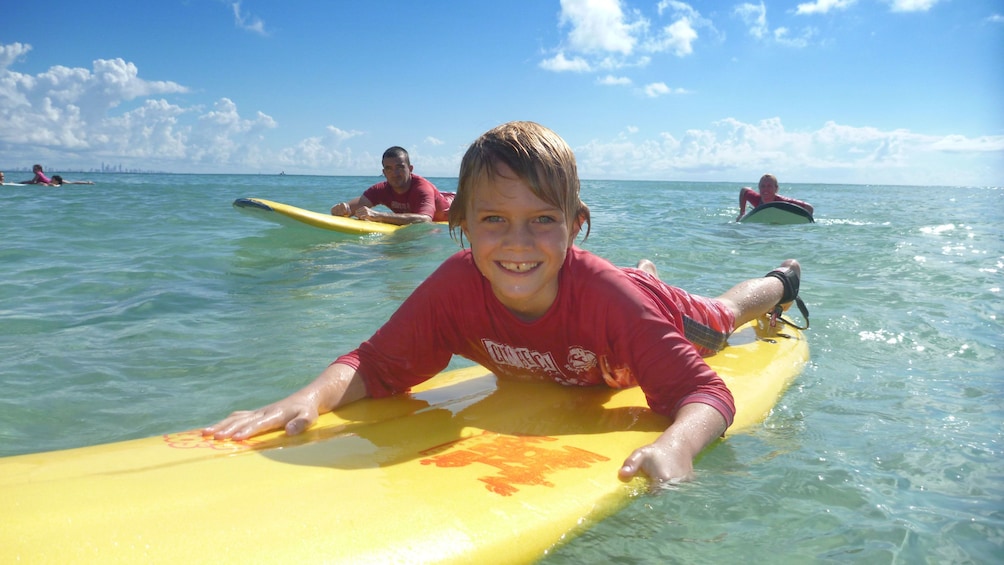 Show item 2 of 4. young boy learning to surf in Gold Coast