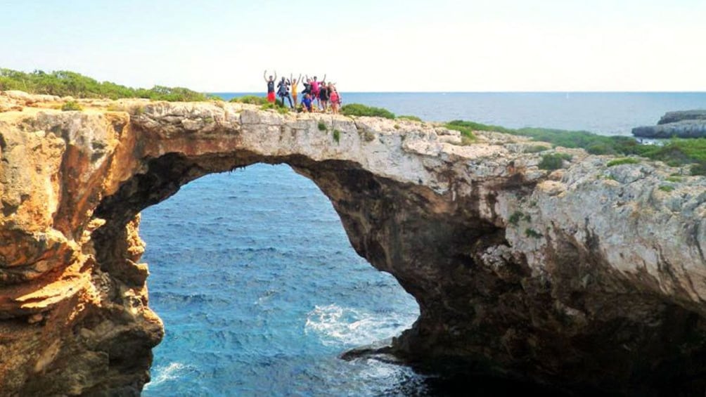 Tour group standing together for a picture before sea caving in Mallorca Island