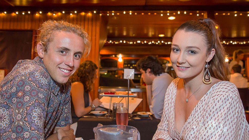 Couple have dinner on cruise in Brisbane