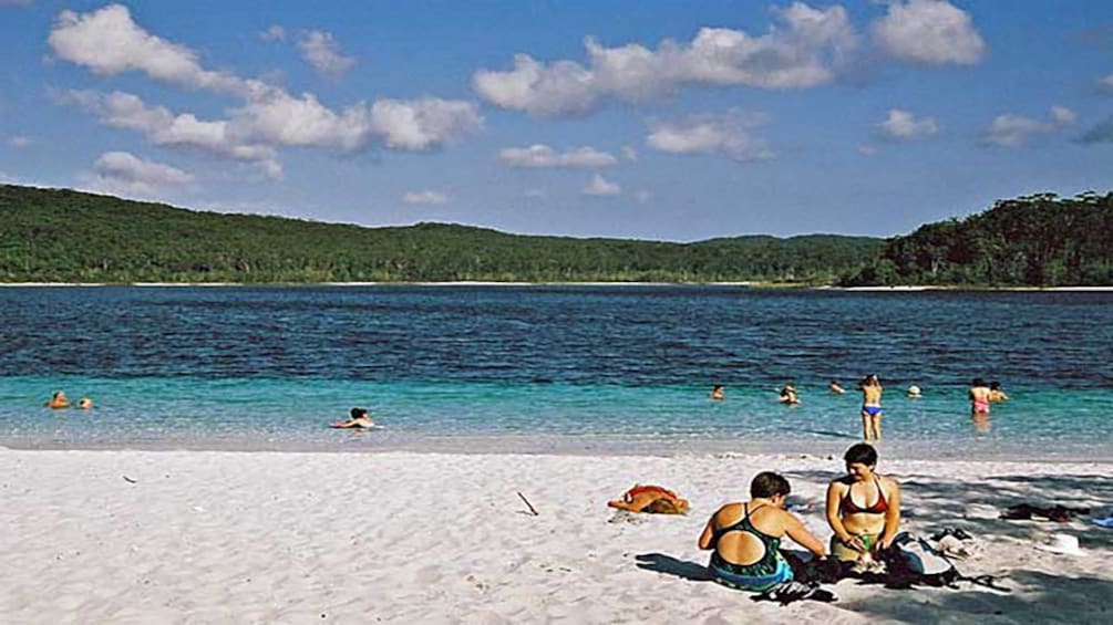 people playing on beach and in water in Brisbane