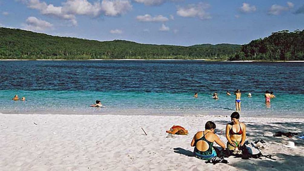 people playing on beach and in water in Brisbane