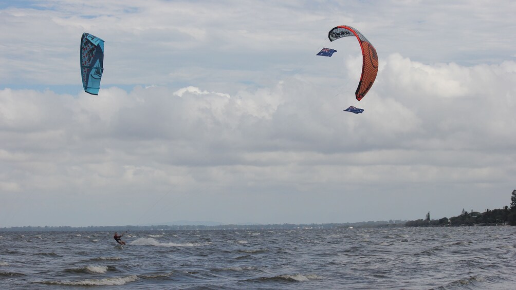 Man with customized kite zipping through the waves