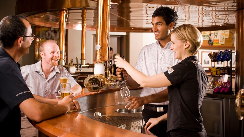 Show item 1 of 8. Taste testing on the Brisbane XXXX Brewery Tour in Australia