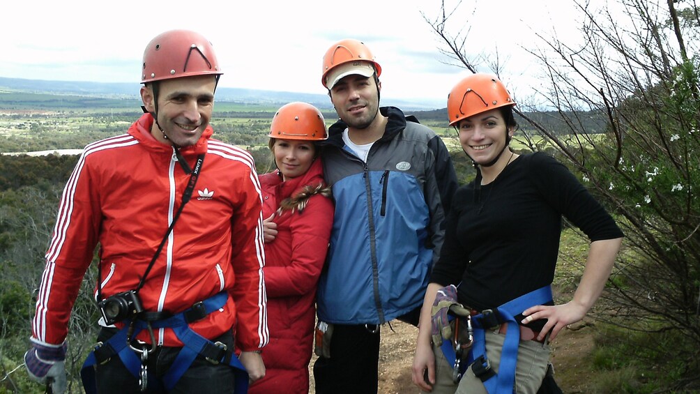 Group of four happy climbers in safety gear in Melbourne