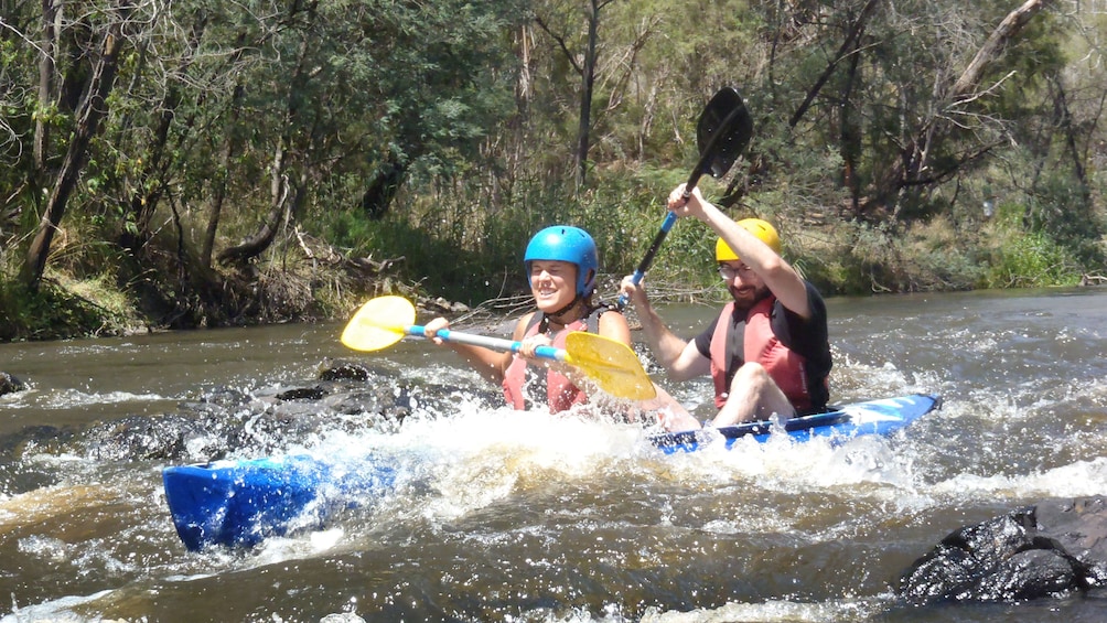 couple paddle through river rapids in Melbourne