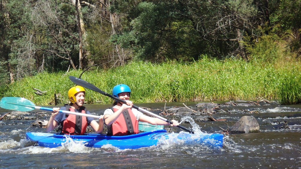 couple paddle through river rapids in Melbourne