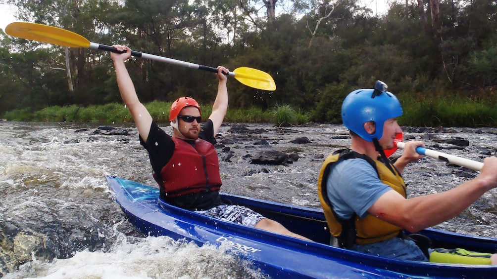 two men in Kayak paddle through rapids in Melbourne