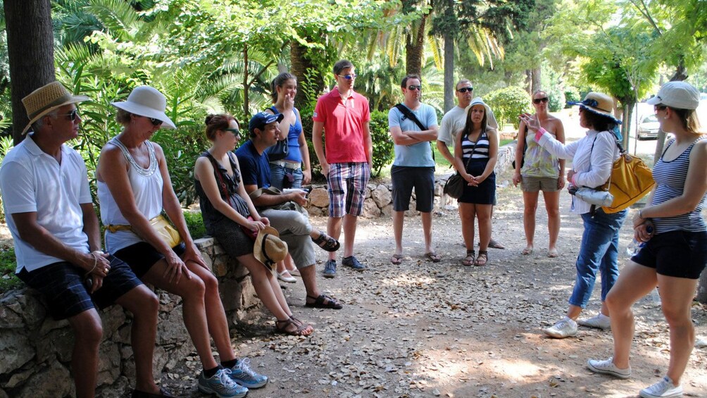 Group listens to guide in Athens