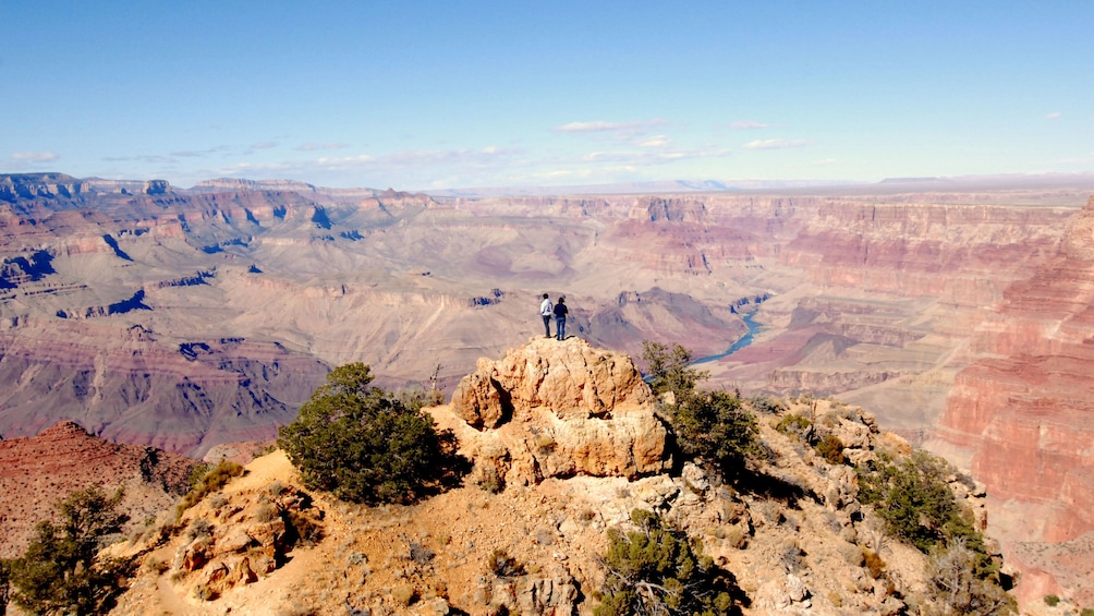 Couple basking the the vastness of the Grand Canyon